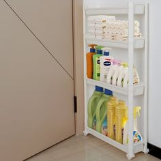 a white shelf filled with cleaning products next to a door