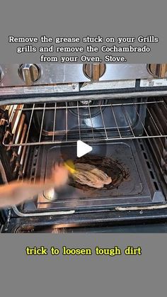 someone is removing food from the oven and pulling it out with their thumbnails