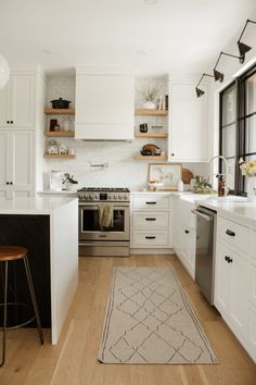 the kitchen is clean and ready for us to use it's white cabinetry