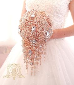 a woman in a wedding dress holding a bridal gown with beadings on it