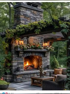 an outdoor fireplace surrounded by greenery and lights