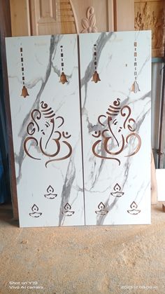 two white marble doors with designs on them