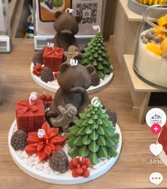 two small christmas trees on plates with bears in the middle one is made out of fondant