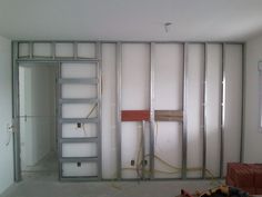 an unfinished room with some shelves and ladders in the wall, next to a fire hydrant