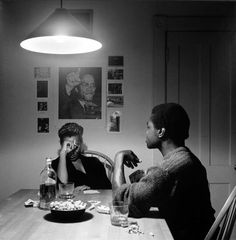 two people sitting at a table with food in front of them