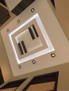 an overhead view of the ceiling in a modern building with recessed lighting and square shapes