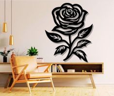 a living room with a chair and wall decal in the shape of a rose