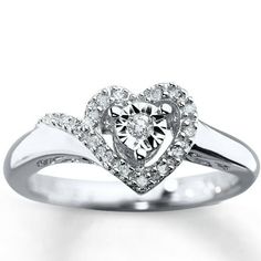 a heart shaped diamond ring with diamonds on it