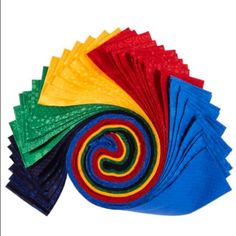 multicolored napkins on white background with one folded in the shape of a spiral