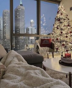 a living room filled with furniture and a christmas tree in front of a large window