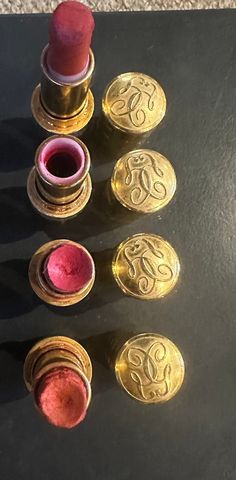 Four Vintage Guerlain KissKiss 1995, Lipsticks, Lip Colour, Lip Rouge. Guerlain brought out these fancy lipsticks in 1995, the tubes are gold metal with raised dimples with fancy Monica on top and a silver colour centre band scribed with GUERLAIN.  Three still have lipstick /lipstick colour. This can be replaced, refilled with up to date cosmetic product.  Great to update or just for display . Lipstick Colour, Lip Colour, Silver Colour, Lipstick Lip, Lipstick Colors, Lip Colors, Silver Color, Gold Metal, Beauty Makeup