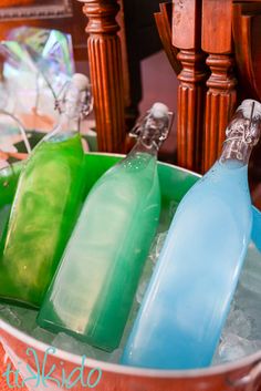 three empty bottles sitting in an ice bucket