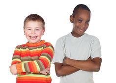 two young boys standing next to each other in front of a white background with their arms crossed