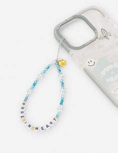 a cell phone case with a beaded bracelet attached to it and a charm that says happy new year