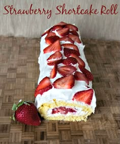 a strawberry shortcake roll with white frosting and sliced strawberries