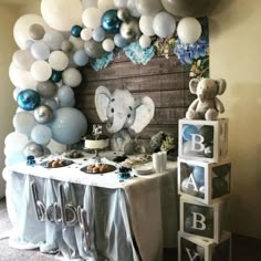 an elephant themed birthday party with balloons and desserts on a table in front of it