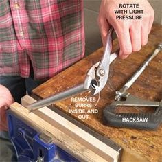 a man is working with some tools on a wooden table and has instructions for how to use them