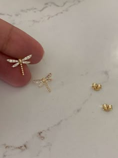 The Gold Dragonfly Studs are perfect for any occasion. Crafted as small earrings, these dragonfly earrings feature tiny cubic zirconia and push backs. A great gift for Valentine's Day, Mother's Day, Anniversaries, and Christmas.♦ Materials: Cubic Zirconia, Gold & Sterling Silver ♦ Available colors: Yellow Gold♦ Closure: Push Backs♦ Earrings Measurements: 15x12 Millimeters------------------------------------------------------------------------------------------MATERIALSSterling Silver, Cubic Zirc Dragonfly Jewelry, Brand Clothes, Dragonfly Earrings, Tiny Studs, Birthday List, Nail Inspiration, Small Earrings, Dragonflies, Gold Earrings Studs