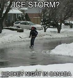 a man is playing hockey in the snow with an ice storm sign on his back