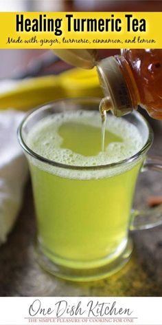 a person pouring tea into a glass cup