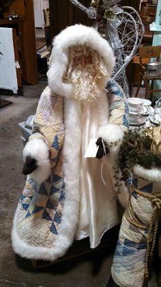 a santa clause sitting on top of a table next to other christmas decorations and decor items