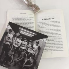 an open book with a photo of boys in football uniforms on it and the pages are black and white