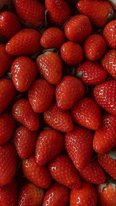 a bunch of strawberries in a white bowl