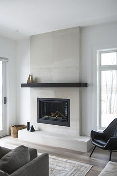 a living room filled with furniture and a fire place in the middle of a room