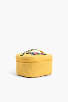 Sturdy top handle Zip closure travel make up bag Spacious Hand embellished zebra with colorful flowers Bright yellow durable fabric Lurex detail gives it a metallic shine Fully lined with an additional zip pocket inside. Size : 9.5" x 5" x 6" The Wild for Travel Make Up Bag is the perfect companion for your next vacation! Crafted with durable and bright yellow fabric, this make up bag is hand embellished with an eye-catching zebra and colorful flowers. The Lurex detail gives it a metallic shine, Beauty Must Haves, Yellow Fabric, Make Up Bag, Travel Pouch, Bold Prints, Hope Chest, Hand Beading, Bright Yellow, Colorful Flowers