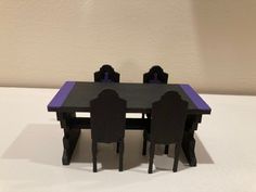 a table and chairs made out of legos on a white surface with a wall in the background