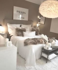 a bedroom with white bedding and fluffy pillows