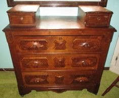 an old wooden dresser with mirror on top