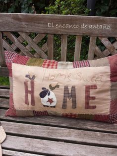 a wooden bench with a pillow on it that says home and a stuffed animal in the middle