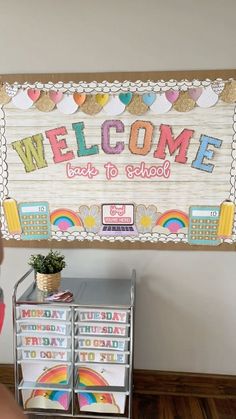 a welcome sign is displayed in front of a bulletin board with school supplies on it