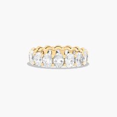 a yellow gold ring with five round diamonds