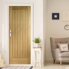 a living room filled with furniture and a wooden door in the middle of it's wall