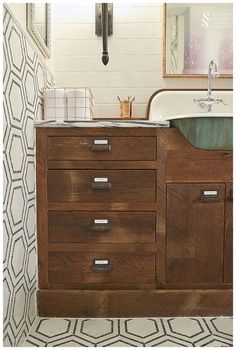 a bathroom with a sink and wooden cabinets