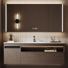 a bathroom with a sink, mirror and lights on the wall above it's counter