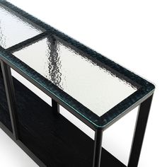 a glass table with metal legs and a black base on an isolated white background for display