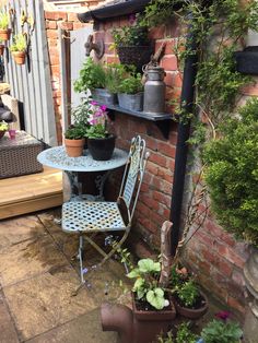 an outdoor patio with potted plants and chairs