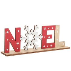 a wooden sign that says noel with snowflakes on it