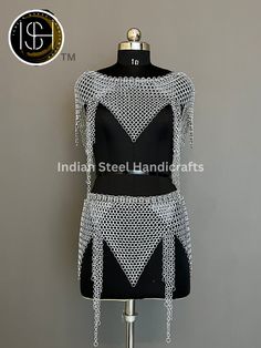 a black and white dress with chains on it