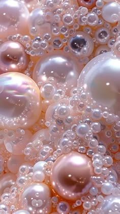 an image of bubbles in the air with some pink and white balls on it's surface