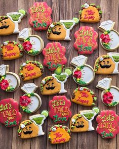 decorated cookies are arranged on a wooden table