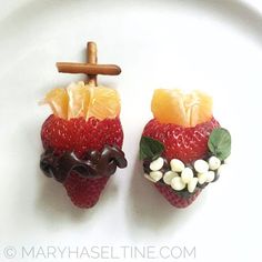 two small strawberries are decorated with chocolate and oranges on a white platter