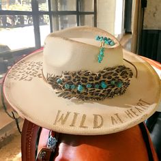 cream/natural/leopard painted and burned rancher hat with leather feather hat band. Burn Hats, Hat Band Ideas, Burnt Hat, Decorated Hats, Womens Western Hats