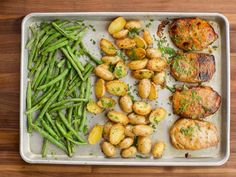 the meal is prepared and ready to be eaten on the table, including potatoes, green beans, and pork chops