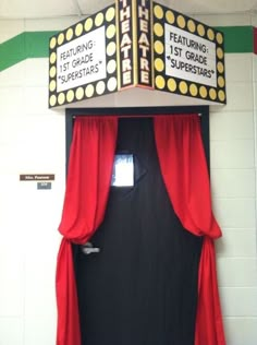 a theater marquee with red curtains and black door