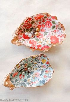 two decorative bowls with flowers and pearls on them