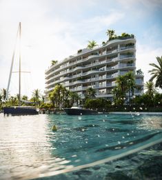 an apartment building sitting on top of a large body of water next to palm trees